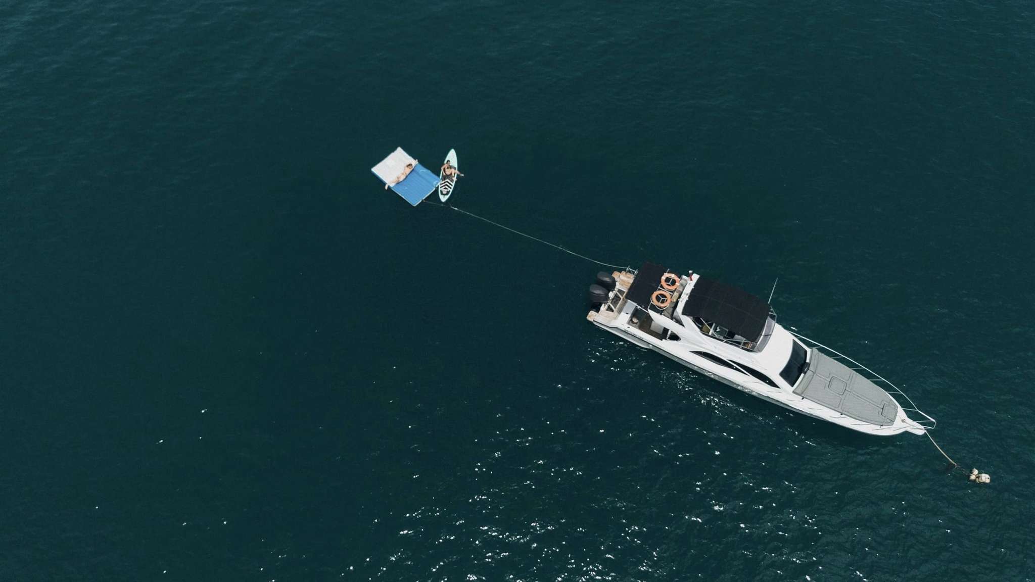 Aerial view of a private yacht cruising the waters off Bali's south coast