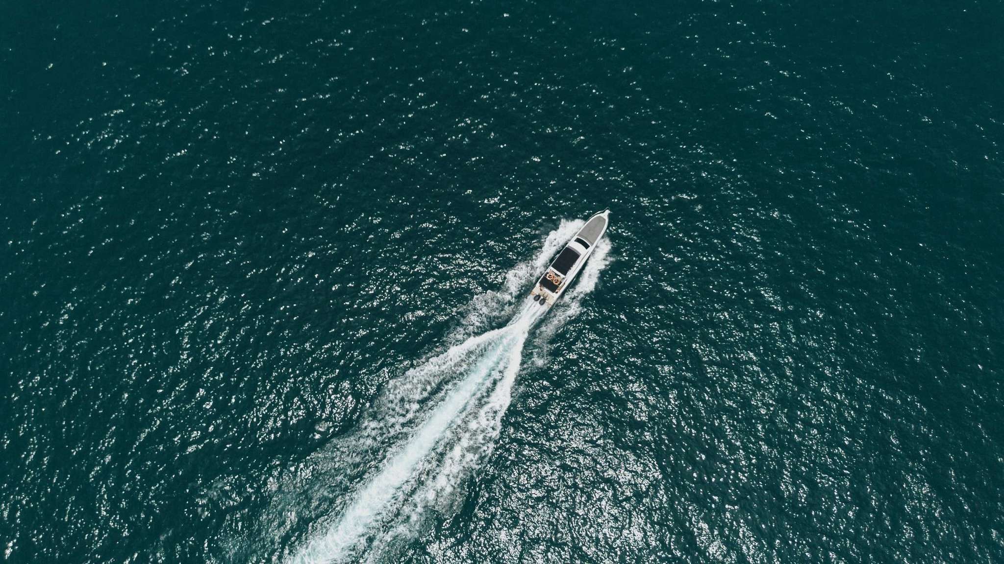 Wide aerial panorama of Freedom Yacht on turquoise water