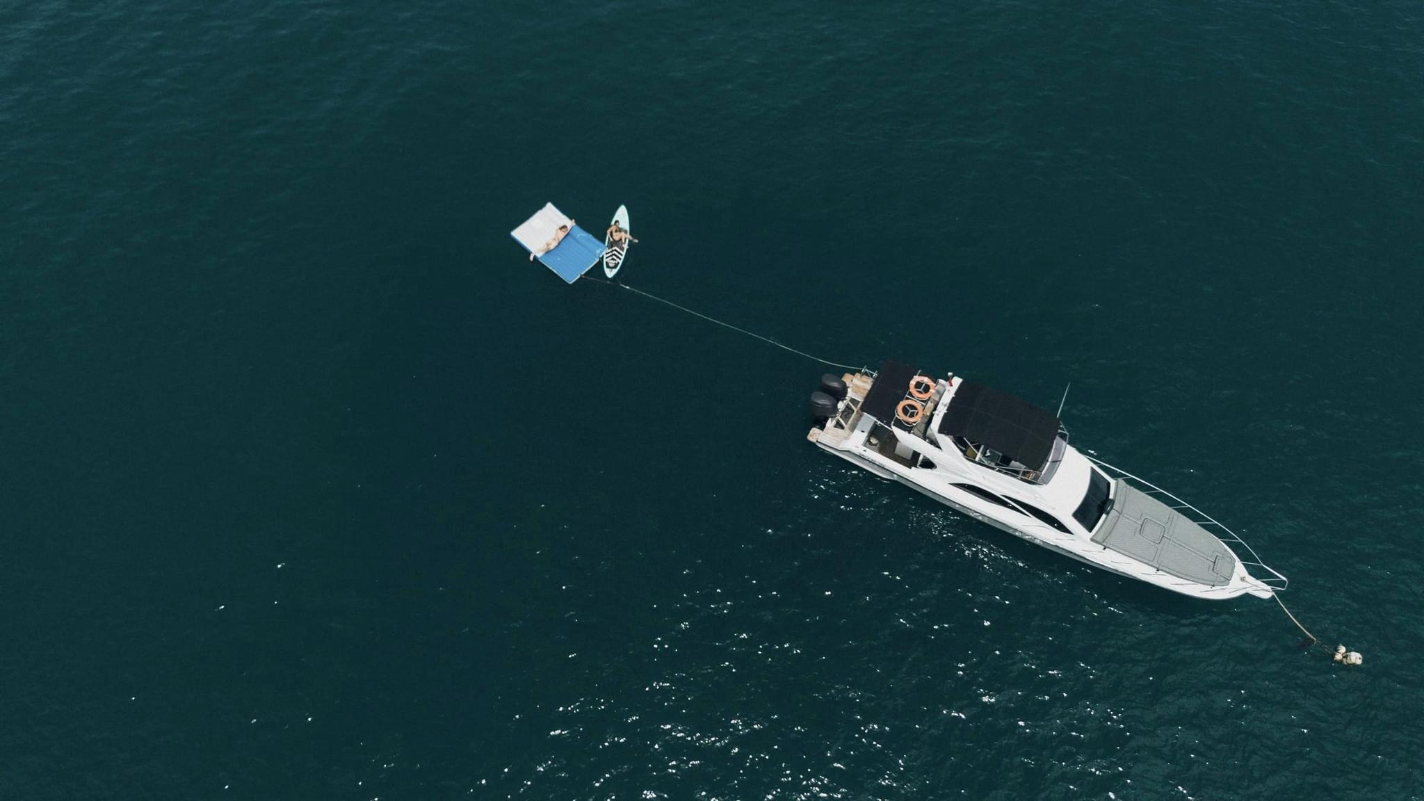 Aerial view of a private yacht cruising the waters off Bali's south coast