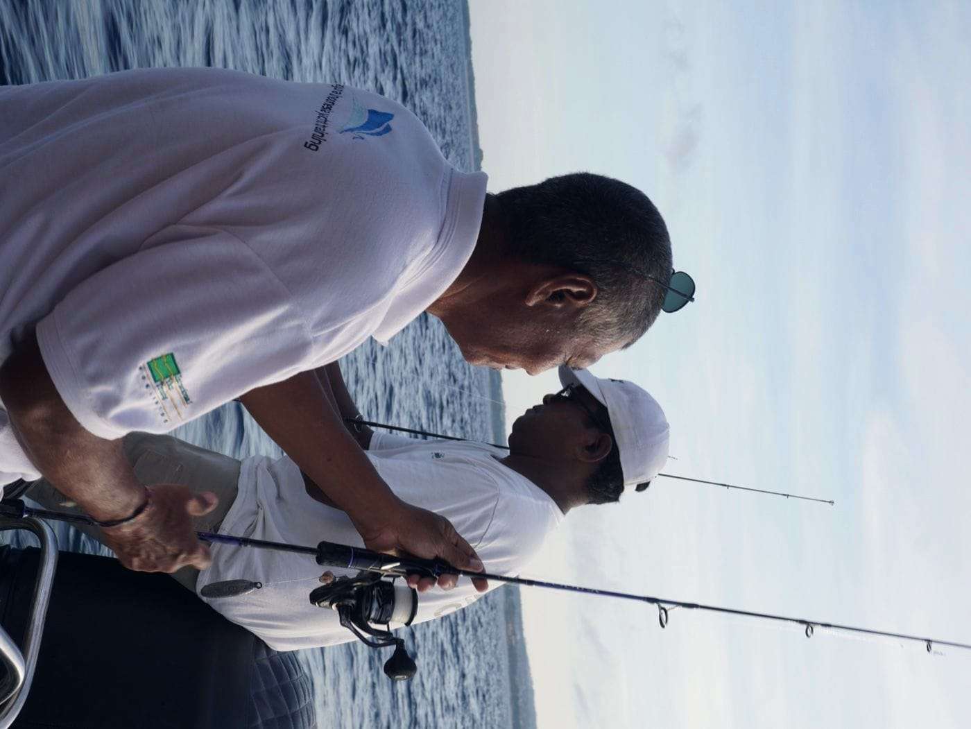Captain and guest discussing a route map on board a private yacht